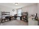 Comfortable home office with a large desk, shelving, and natural light at 6681 Keepsake Dr, Whitestown, IN 46075