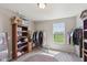 Bright walk-in closet offers open window and garment racks for easy access at 6681 Keepsake Dr, Whitestown, IN 46075