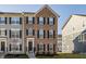 Attractive townhouse showcasing brick facade, black shutters, and a well-maintained front yard at 6953 Equality Blvd, Carmel, IN 46033