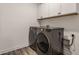 Laundry area featuring a front load washer and dryer and overhead storage cabinets at 6953 Equality Blvd, Carmel, IN 46033
