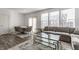 Bright open-concept living area with dining table, sofa, glass table and large windows at 6953 Equality Blvd, Carmel, IN 46033
