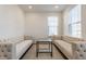 Bright, open living room with matching tufted sofas, hardwood floors, and a stylish glass coffee table at 6953 Equality Blvd, Carmel, IN 46033