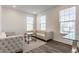 Bright living room with tufted sofa, glass tables, and abundant natural light from large windows at 6953 Equality Blvd, Carmel, IN 46033