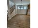 Spacious dining room with a staircase, wood-look floors, natural light from windows, and contemporary chandelier at 798 James William Ln, Westfield, IN 46074