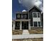 New construction two-story home with a welcoming front porch, dark siding, and large windows under a sunny, cloudy sky at 798 James William Ln, Westfield, IN 46074