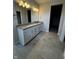 Bathroom featuring a dual granite vanity, tile flooring, and modern fixtures at 799 Rose Garden Way, Westfield, IN 46074