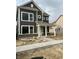 New construction two-story home with dark siding, white trim, covered porch, and freshly poured concrete sidewalk at 799 Rose Garden Way, Westfield, IN 46074