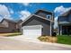 Side view of a two-story home with a white garage door, concrete driveway, and vinyl siding at 799 Rose Garden Way, Westfield, IN 46074