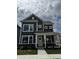 Charming two-story home with dark siding, a covered porch, and large windows showcasing its inviting facade at 799 Rose Garden Way, Westfield, IN 46074