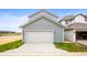 Exterior view of a home with a two-car garage with light-blue horizontal siding at 799 Rose Garden Way, Westfield, IN 46074