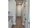Bright hallway with a light wood floor leading to a white door at the end at 799 Rose Garden Way, Westfield, IN 46074