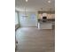 Open-concept kitchen with white cabinets, granite countertops, pendant lighting, and stainless steel appliances at 799 Rose Garden Way, Westfield, IN 46074