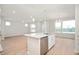 Bright and open kitchen with modern island, stainless steel appliances, and light hardwood floors at 799 Rose Garden Way, Westfield, IN 46074