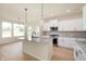 A modern kitchen with a granite island, stainless appliances, and gorgeous countertops at 799 Rose Garden Way, Westfield, IN 46074