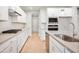 Elegant kitchen with stainless steel appliances, white cabinets, gray countertops, and a gas range at 799 Rose Garden Way, Westfield, IN 46074
