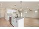 Modern kitchen island with granite countertops, a sink, and stainless steel appliances at 799 Rose Garden Way, Westfield, IN 46074