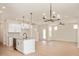 Open-concept kitchen with granite island, pendant lighting, and seamless flow to the living area at 799 Rose Garden Way, Westfield, IN 46074