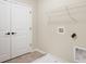 Laundry room featuring white shaker doors, a metal shelf, and tile flooring at 799 Rose Garden Way, Westfield, IN 46074