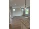 Bright living area with luxury vinyl plank flooring, ample windows, and modern pendant lighting over the kitchen island at 799 Rose Garden Way, Westfield, IN 46074