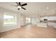 Bright and airy living room with modern ceiling fan and large windows offering neighborhood views at 799 Rose Garden Way, Westfield, IN 46074
