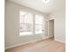 A bright room with beautiful floors, two windows, white walls, and a door at 799 Rose Garden Way, Westfield, IN 46074