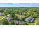 Aerial view of a community featuring tennis courts surrounded by lush trees at 8158 Shorewalk Dr # F, Indianapolis, IN 46236