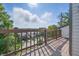 A balcony with a wood deck and railing offers great views of the trees and neighborhood at 8158 Shorewalk Dr # F, Indianapolis, IN 46236
