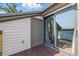 A sliding glass door can be seen leading to the balcony with wood floors and white siding at 8158 Shorewalk Dr # F, Indianapolis, IN 46236