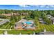 An aerial view shows the community pool, surrounded by lush landscaping and neighborhood homes at 8158 Shorewalk Dr # F, Indianapolis, IN 46236
