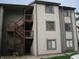 View of the condo building's exterior with wood stairs leading to upper levels at 8158 Shorewalk Dr # F, Indianapolis, IN 46236