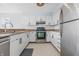 Well-lit kitchen featuring modern appliances, white cabinetry, and granite countertops for a clean, stylish look at 8158 Shorewalk Dr # F, Indianapolis, IN 46236
