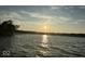 Sunset view over a lake, trees and water at 8158 Shorewalk Dr # F, Indianapolis, IN 46236