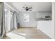 Bright living room featuring a ceiling fan, sliding door, and an open layout leading to the kitchen at 8158 Shorewalk Dr # F, Indianapolis, IN 46236