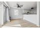 Open-concept living area seamlessly connects to the kitchen, featuring a ceiling fan and sliding door access at 8158 Shorewalk Dr # F, Indianapolis, IN 46236