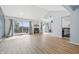 Bright living room featuring vaulted ceilings, a cozy fireplace, and sliding doors to a private balcony at 8158 Shorewalk Dr # F, Indianapolis, IN 46236