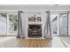 Cozy living room with a fireplace, sliding doors leading to a balcony, and bright natural light at 8158 Shorewalk Dr # F, Indianapolis, IN 46236