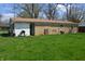 Spacious backyard with a well-maintained lawn and view of the home's exterior at 838 Highland Dr, Whiteland, IN 46184