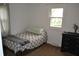 Simple small bedroom featuring a dresser and sunny view from the window at 838 Highland Dr, Whiteland, IN 46184