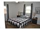 Cozy bedroom with a ceiling fan, natural light, and simple elegant decor at 838 Highland Dr, Whiteland, IN 46184