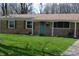 Close up of a brick home with a light teal front door and well-maintained lawn at 838 Highland Dr, Whiteland, IN 46184