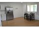 Bright, spacious kitchen boasts wood floors, stainless steel refrigerator, and a dining area by the window at 838 Highland Dr, Whiteland, IN 46184