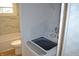 A laundry room with marble tiled walls, a bathtub with shower, and a washing machine at 838 Highland Dr, Whiteland, IN 46184
