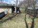 Fenced backyard featuring a storage shed and mature trees at 8625 Edith St, Martinsville, IN 46151