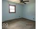 Bedroom with window, hardwood trim, and ceiling fan at 8625 Edith St, Martinsville, IN 46151