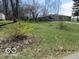 Front yard with grassy area, driveway, and stone facade home at 8625 Edith St, Martinsville, IN 46151