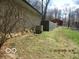 Landscaped side yard featuring a retaining wall and fencing at 8625 Edith St, Martinsville, IN 46151