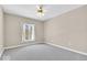 Spacious bedroom with neutral walls, ceiling fan, and large window at 8717 Vintner Ct, Indianapolis, IN 46256