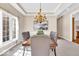 Elegant dining room featuring a tray ceiling, chandelier, and large windows at 8717 Vintner Ct, Indianapolis, IN 46256
