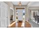 Bright foyer with hardwood floors and views into the dining and living areas at 8717 Vintner Ct, Indianapolis, IN 46256