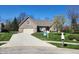 Beautiful home with manicured front yard, mature trees, and a 'For Sale' sign on a sunny day at 8717 Vintner Ct, Indianapolis, IN 46256